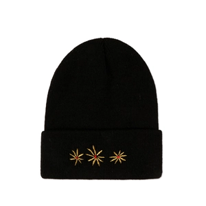 Detailed close-up of golden star floral embroidery on a black knit beanie hat