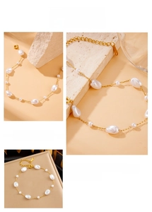 Detail of gold chain bracelet featuring irregular baroque pearls and minimalist style