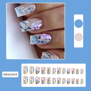 Detail of pink hand-painted flower nails with blue gold foil and black line accents