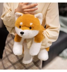 Realistic Shiba Inu plush pillow held by a person in a cozy domestic home setting