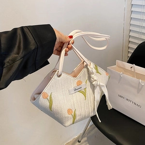 Minimalist canvas tote bag with tulip embroidery and decorative silk ribbon handle
