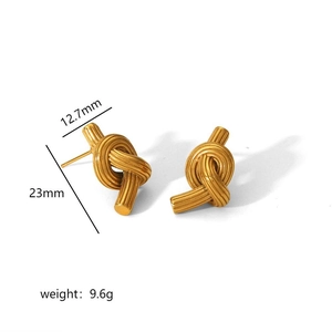 Detailed view of gold knot earrings showing 23mm height and 9.6g weight dimensions