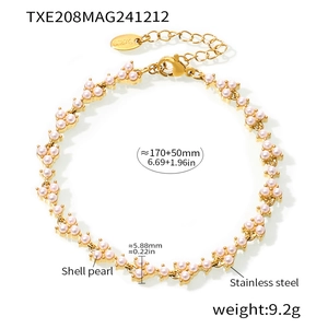 Macro detail of stainless steel bracelet with pink shell pearl clusters and lobster clasp