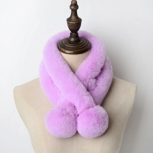 Detail of purple faux rabbit fur scarf with plush pom-poms on a professional mannequin
