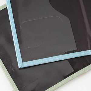 Detail of passport cover stitching with blue and green piping and a clear card slot