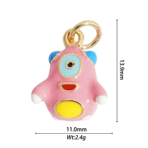 Detailed view of pink monster pendant with dimensions 13.9mm by 11.0mm in gold and enamel