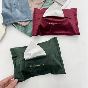 Macro view of velvet tissue pouches with gold Happiness embroidery in multiple colors