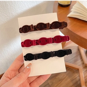 Three velvet braided hair clips in dark brown, burgundy and black on card display