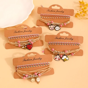 Detailed set of bohemian hand-woven bracelets with cute cartoon charms on display