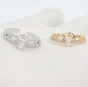Macro detail of crown rings in gold and silver finish with sparkling cubic zirconia