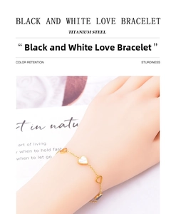 Detailed macro of gold titanium steel heart bracelet with black and white shells