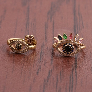 Detailed view of evil eye adjustable rings in gold with colorful zircon stones on leather