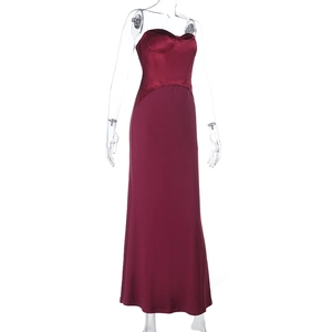 Detailed close-up of the burgundy satin gown featuring a structured bustier and bone bodice