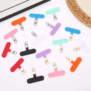 Detailed close-up of colorful T-shaped TPU phone lanyard tabs with rotating metal clips