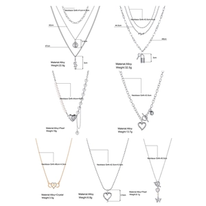 Detailed view of alloy heart and butterfly necklaces with pearls and OT clasps