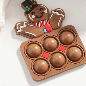Brown gingerbread man pop fidget toy keychain with silicone bubbles and striped scarf