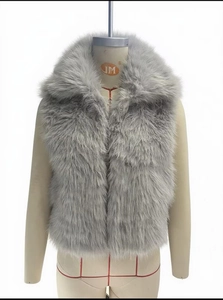 Detailed view of fluffy light gray faux fur texture on a short sleeveless vest