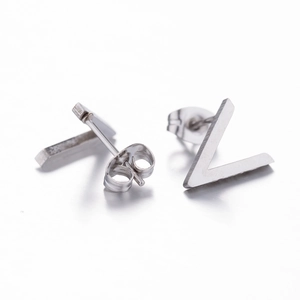 Macro shot of minimalist stainless steel asymmetric stud earrings in bar and V shapes