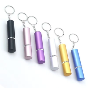 Portable 5ml perfume atomizers in six metallic colors with keychain chains on white background