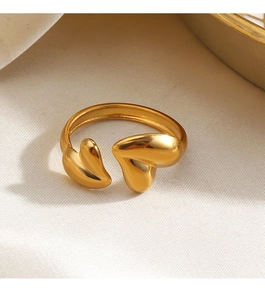 Detailed close-up of 18K gold plated heart ring on a soft silk fabric background