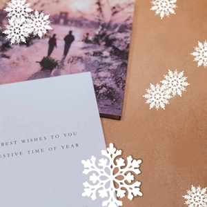 Festive Christmas card with snowflake decor and Best Wishes text on kraft paper