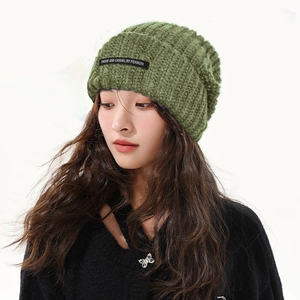 Grass green chunky knit slouchy beanie for women featuring a stylish unique black label