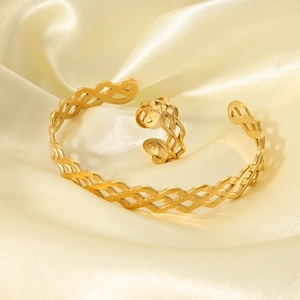 Luxury 18K gold plated hollow wave pattern cuff bracelet and ring set on beige silk