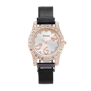 Close-up of rose gold diamond-set watch case with a black magnetic Milanese mesh strap