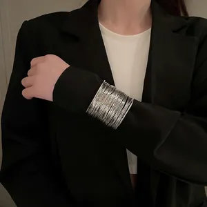 Exaggerated silver multi-layer hollow arm cuff bracelet with a minimalist modern design
