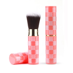 Portable coral pink retractable makeup brush with checkered pattern and soft gradient bristles