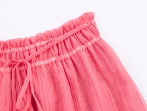 Detail of the elastic waistband with drawstring and pleated texture on pink bohemian dress