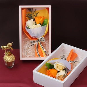 Artificial soap rose flower gift boxes in orange and cream white with ribbons