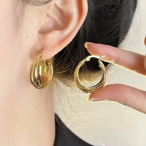 Classic gold triple hoop earrings featuring a trendy three-in-one layered cross design