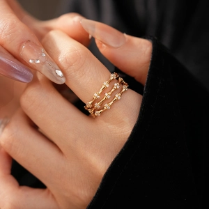 Detail of three-layer bamboo joint ring in gold finish with zircon inlay on hand