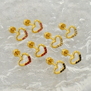 Detailed view of four pairs of gold heart stud earrings with colorful rhinestones