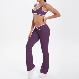 Detail of dark purple yoga set with white trim and crossover high waist flare pants
