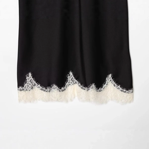 Women's black satin lace top with white eyelash lace trim detailing and silky texture