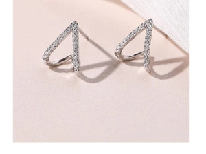 Macro shot of V-shaped sterling silver earrings with micro-paved white zircon stones