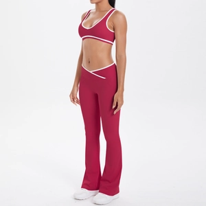 Detail view of deep red yoga set featuring white contrast trim and crossover high waistband