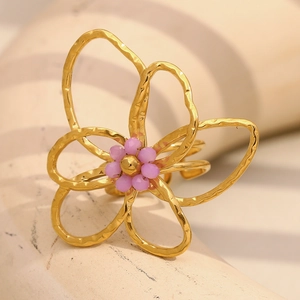 18K gold plated flower ring with purple bead center on minimalist display stand