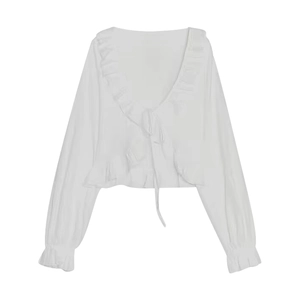 Detail showing white V-neck blouse with ruffled edges and drawstring tie front
