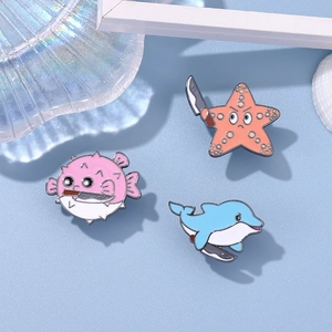 Cartoon ocean animal enamel pins set featuring a pufferfish starfish and dolphin with knives