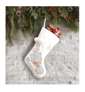 White plush Christmas stocking with snowflake embroidery and decorative pom poms