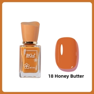 Macro shot of 14ml honey butter yellow nail polish bottle with unique orange cap