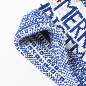 Blue and white knitted Christmas beanie featuring festive reindeer and letter patterns
