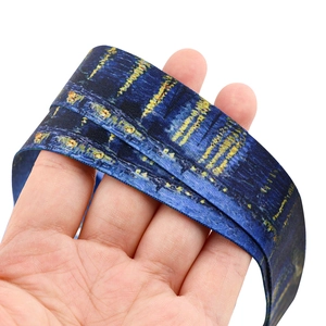 Detail of Starry Night print lanyard with smooth polyester texture and artistic oil strokes