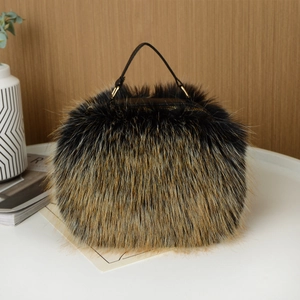 Close-up of black-brown faux fur handbag with black leather handle and gold hardware