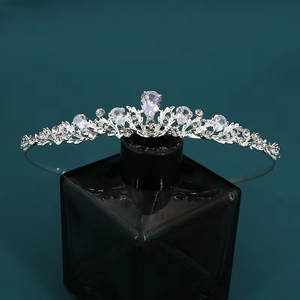 Detail of luxury silver bridal crown with sparkling zircons on a dark display stand
