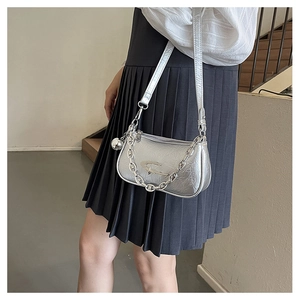 Detail of silver pleated shoulder bag featuring metallic texture and chain strap