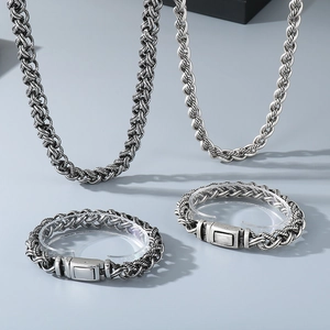 Macro view of vintage silver braided chain necklaces and bracelets with oxidized finish